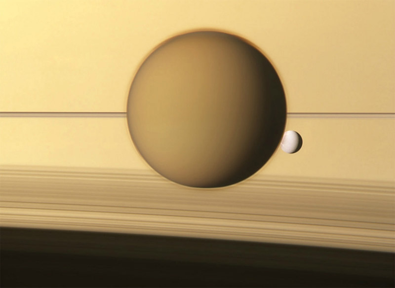 Титан и Диона на фоне атмосферы Сатурна